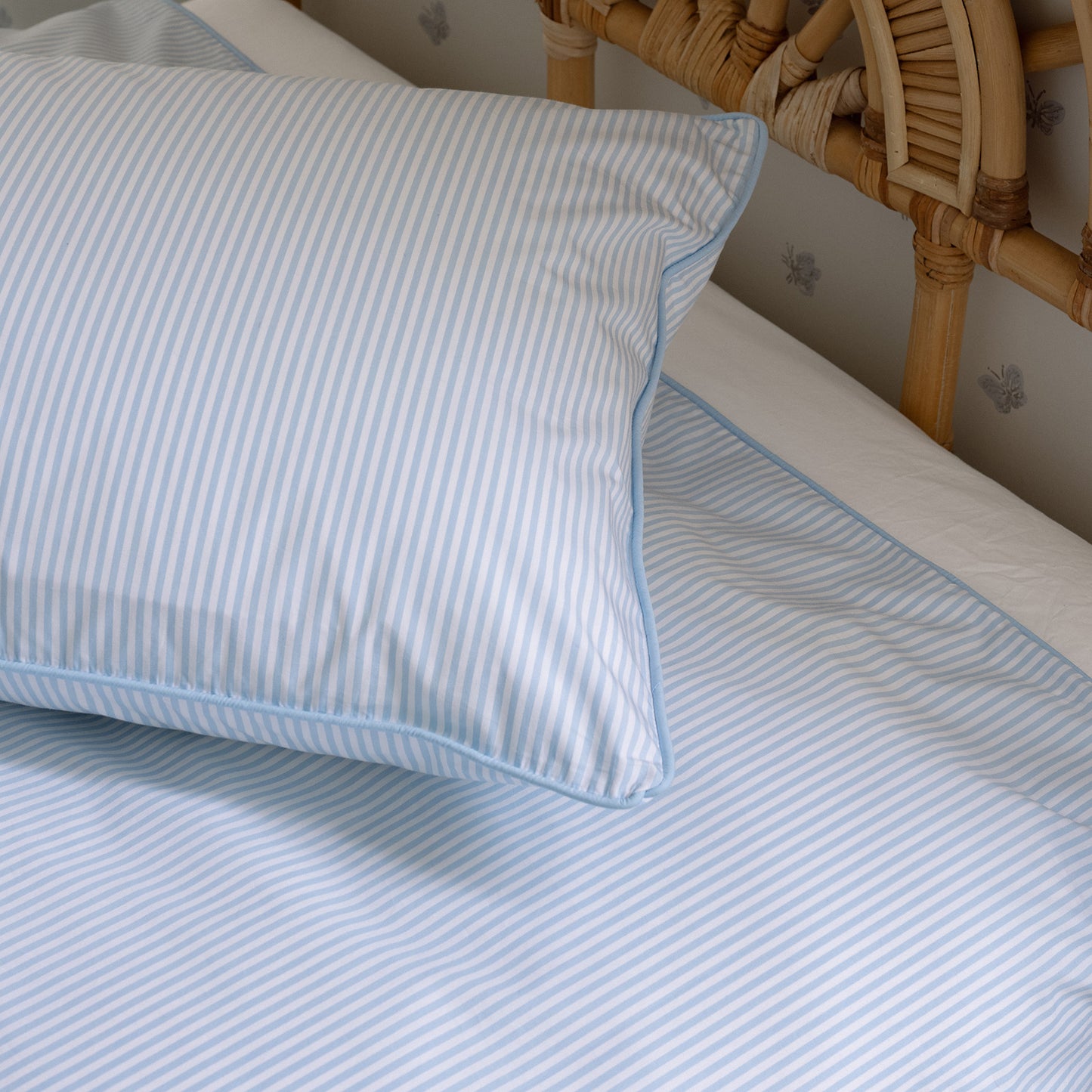 close up of blue and white stripe bed linen
