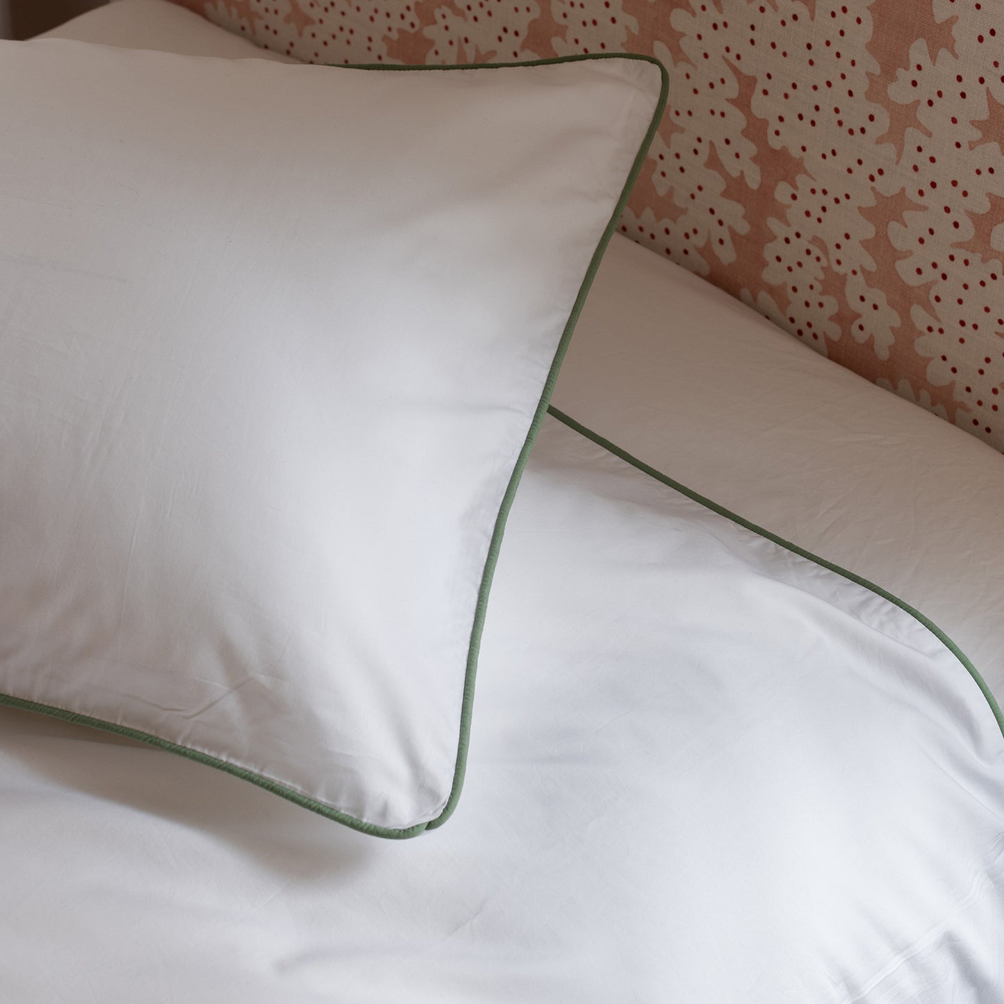 close up of sage piped border bedding set