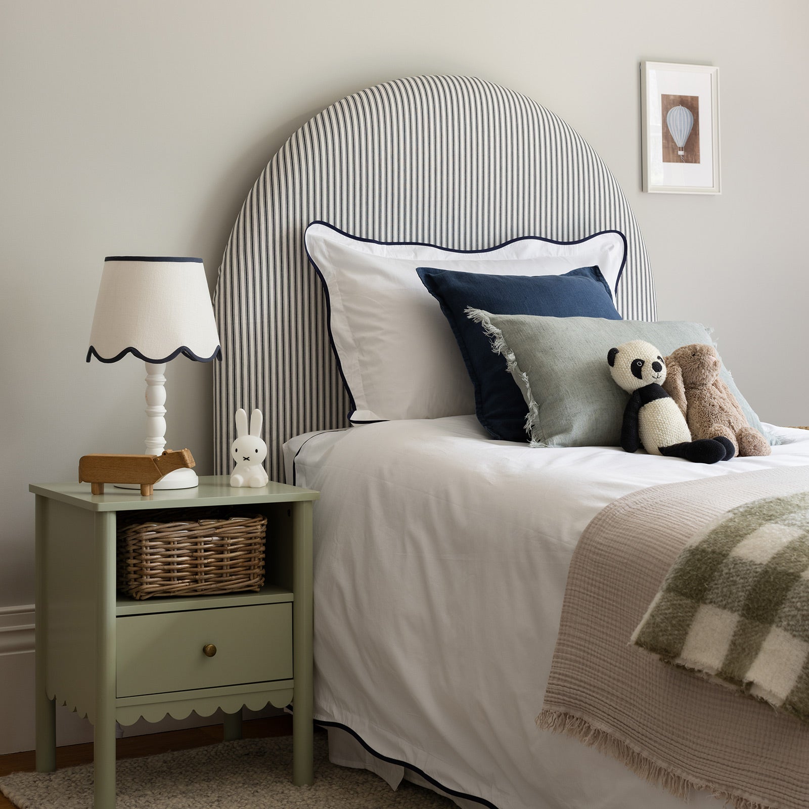 side view of stylish bedroom using navy wave border bed linen