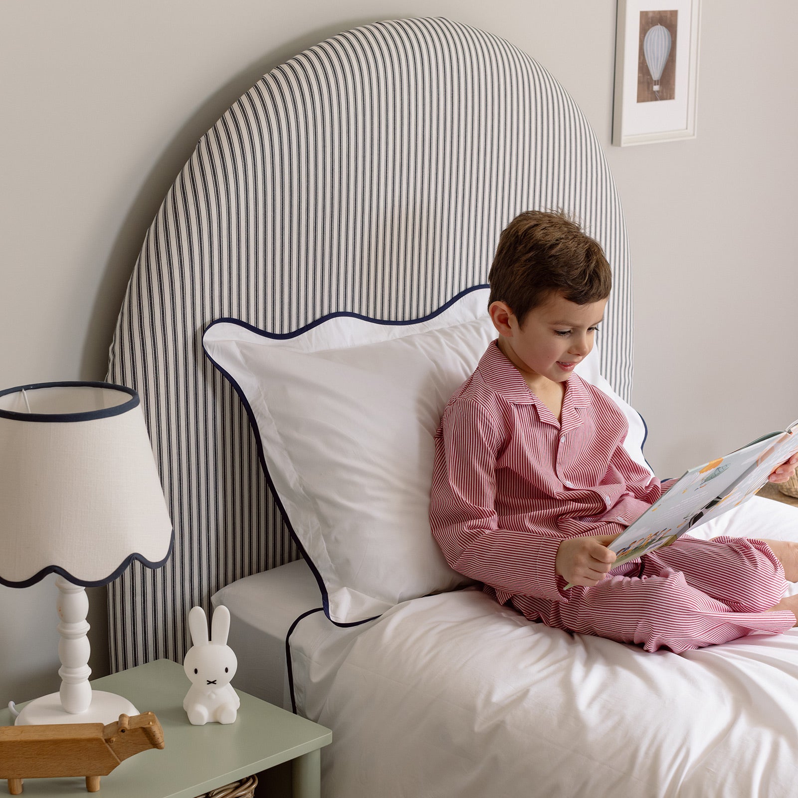 boy reading a book before bedtime